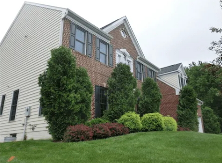 Client photo of a brick home front yard before landscaping